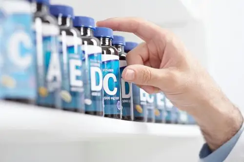 A slice of keto vanilla cake served on a white plate with a fork.